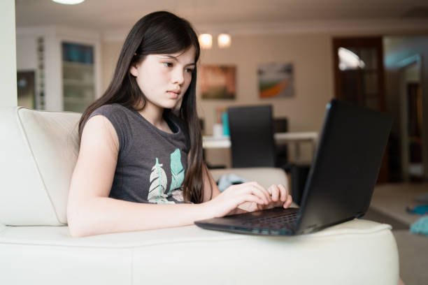 istock Teenage girl using laptop. 1072417090