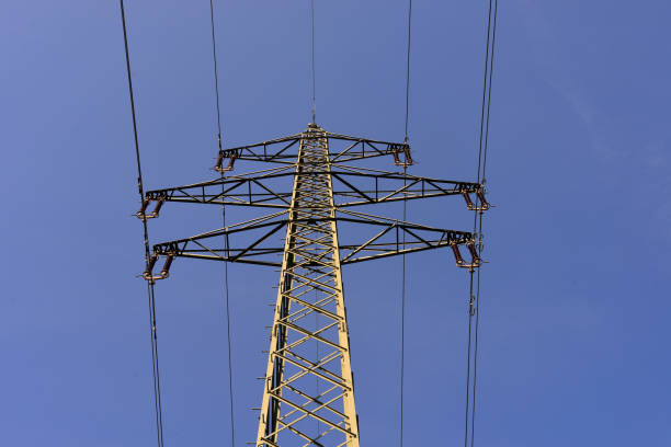 istock Electricity pylon with high voltage power line in front of blue sky 1072417522