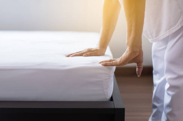 istock Make a bed,Woman hand making her bed in room after wake up 1072417630