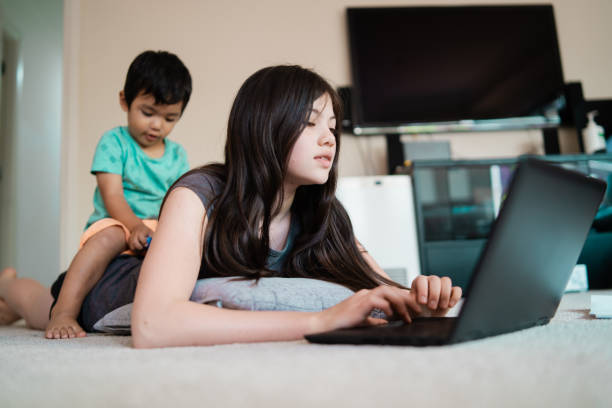 istock Mixed race kid at home on laptop. 1072418008