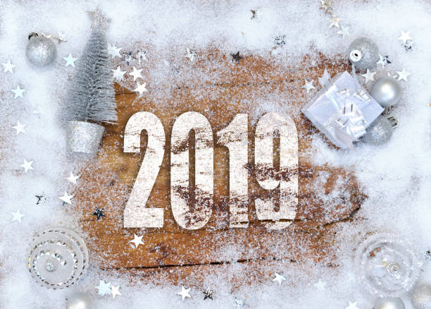 istock 2019 new year on a plank and silver christmas decoration 1072420462