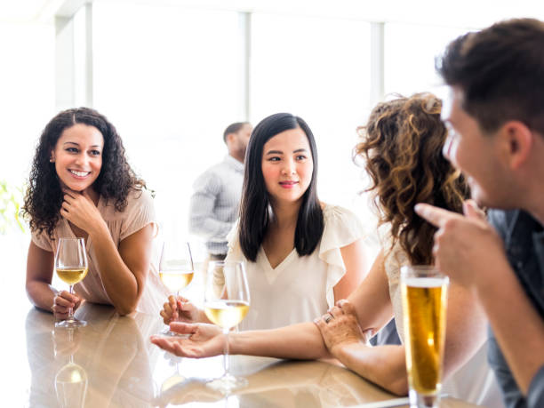 istock Coworkers talking while enjoying alcohol in office 1072422418