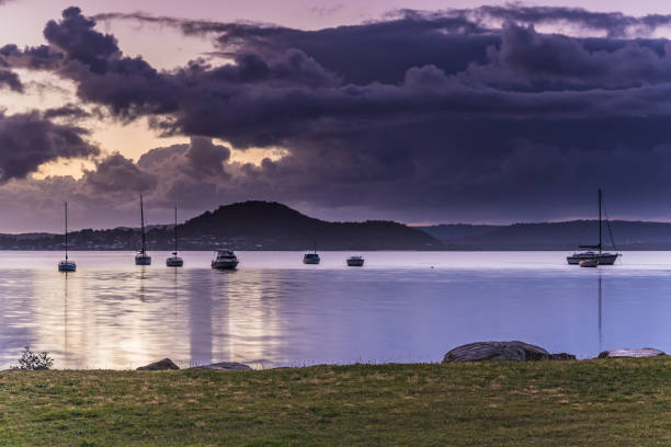 istock Sunrise Waterscape with Clouds and Boats 1072423484