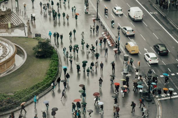 vista aérea de pessoas com guarda-chuvas em barcelona - umbrella parasol rain rush hour - fotografias e filmes do acervo