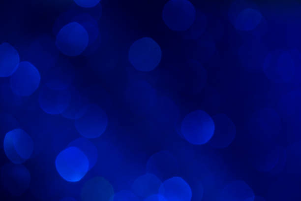 istock blue shiny bokeh background. festival celebration background concept. 1072427584