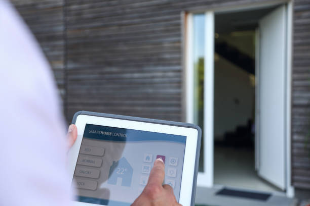 istock Controlling smart home with digital tablet - door locking 1072436034