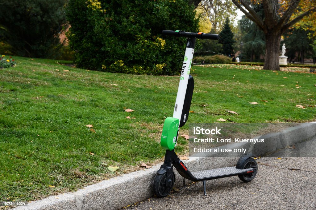 scooter Madrid, Spain - November 22, 2018: Electric scooter. Can be rented and then abandoned in the public via. Are located by GPS and are collected by employees of the company Lime Stock Photo