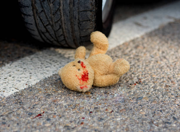 istock toy bear under the car wheels 1072450626