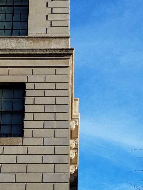 istock Architectural detail, limestone facade and cornices, quoined corner. 1072459800