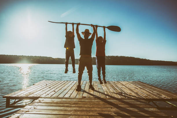 istock Father and two sons playing on pier. 1072461960
