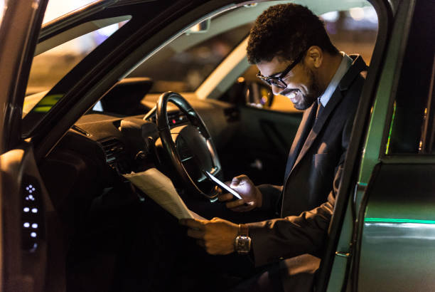 istock Manager reading report in car late at night 1072462036