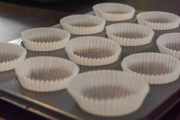 istock Baking tin with empty muffin cups made of baking paper 1072463352