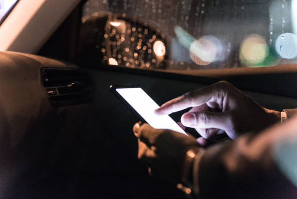 Sitting in car and typing on smart phone