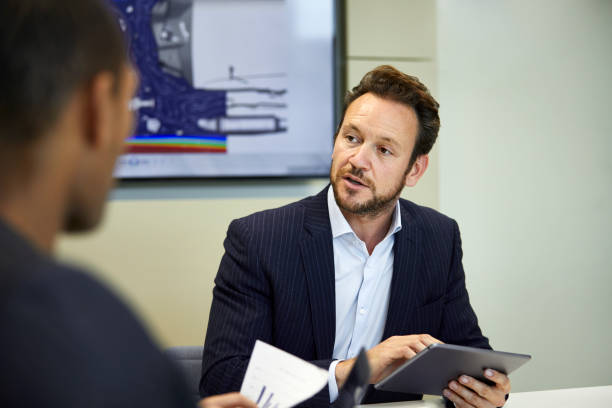 istock Businessman using digital tablet in meeting 1072465510