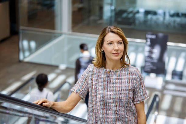 istock Thoughtful mature businesswoman on escalator 1072465850