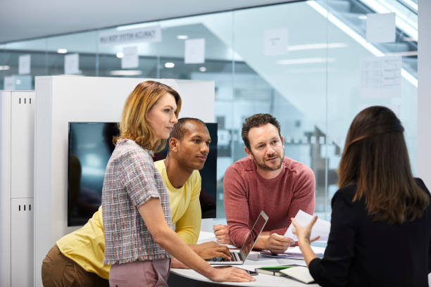 istock Businesswoman explaining colleagues in meeting 1072465916