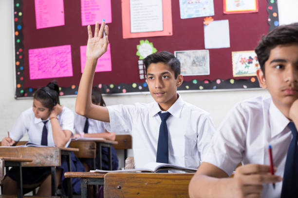 istock Female student in classroom questioning  - Stock image 1072467596