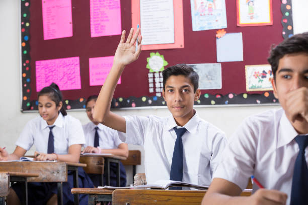 istock Female student in classroom questioning  - Stock image 1072468670