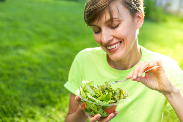 istock Woman eating salad 1072469916