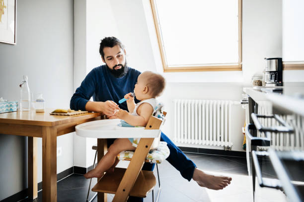 istock Single Father Feeding His Baby 1072469940