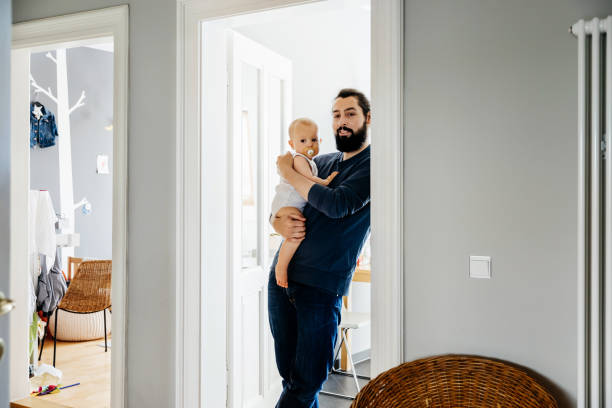 istock Single Father Carrying Baby At Home 1072469946