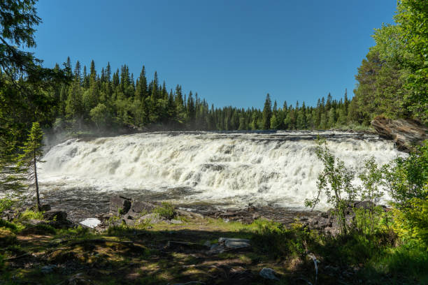 istock Wide waterfall in bright summer sunshine 1072470248