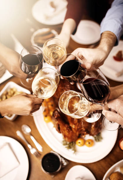 Cropped shot of a group of people making a toast over Christmas lunch