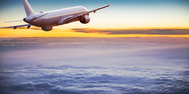 istock Commercial airplane flying above dramatic clouds. 1072472372