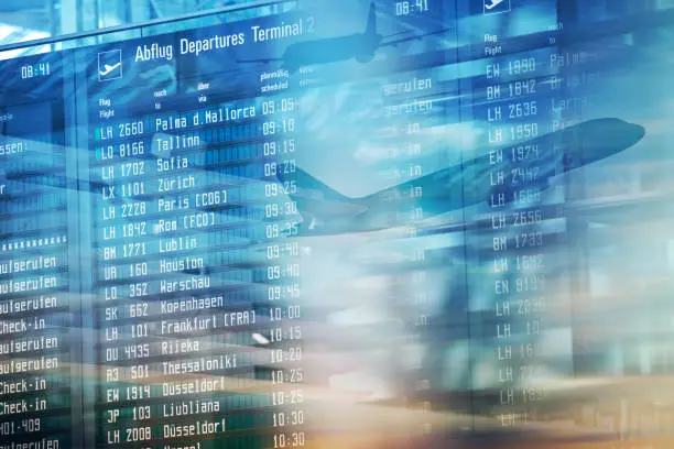 Photo of Flights information departures board in airport terminal.