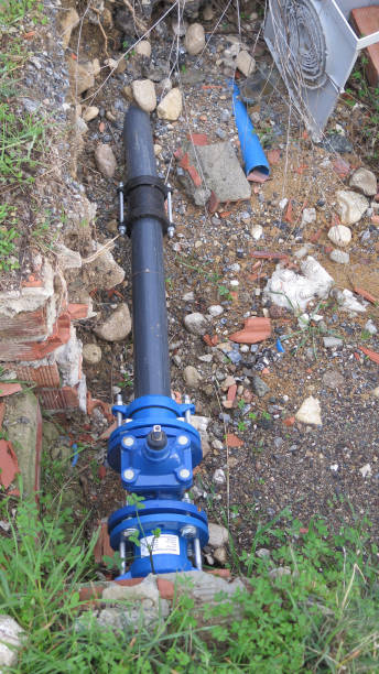 istock Exposed water pipe and control in roadside repair site 1072478638
