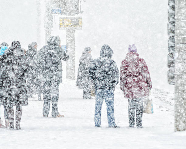 istock People on bus stop in snowfall 1072479322
