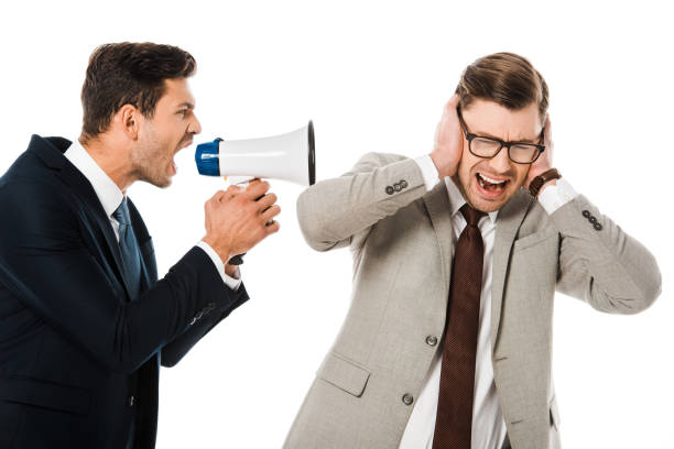istock angry boss shouting with loudspeaker at scared employee isolated on white 1072480908
