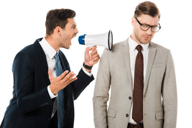 istock aggressive boss yelling with megaphone at upset employee isolated on white 1072480910