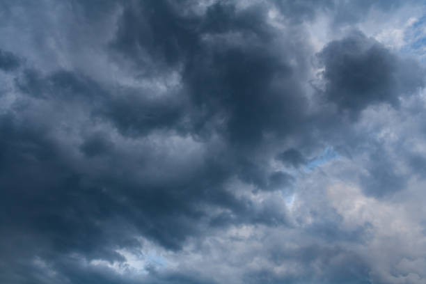 istock Low dark storm clouds in the overcast sky (background) 1072486884