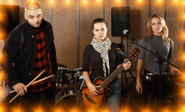 istock expressive group of rock musicians posing with instruments 1072487490