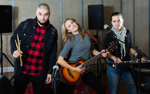 istock group of rock musicians posing with instruments 1072487500