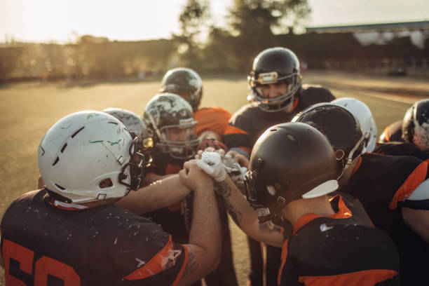 istock American football team holding hands 1072492540