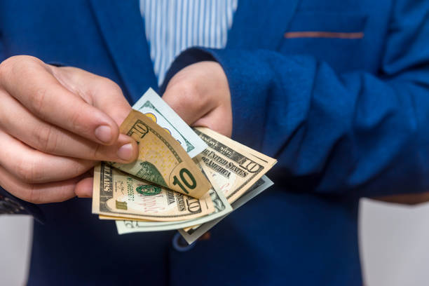 istock Male hands counting dollar banknotes close up 1072493468