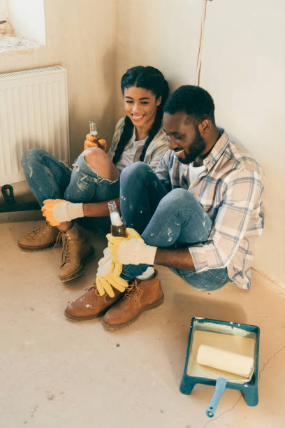 istock high angle view of couple sitting on floor with beer while making renovation of home 1072496310