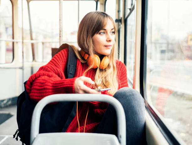 Young woman riding in public transportation stock photo
