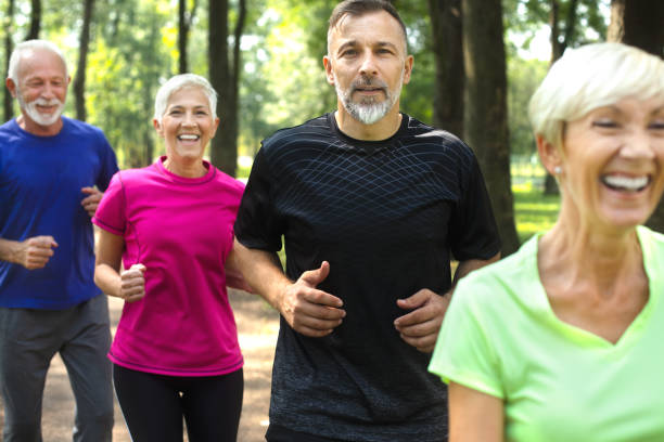 istock Active senior people jogging together in a park 1072503732