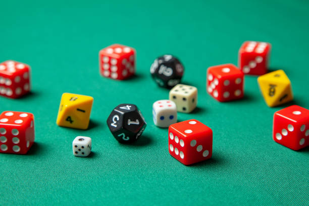 istock Collection of colored gaming dice cubes on green table 1072504620