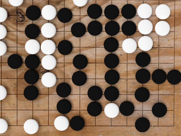 istock Desk for board game Go and black and white bones. Traditional asian strategy board game , 3d rendering 1072514488