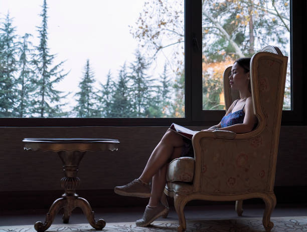 Woman having rest in luxury hotel lobby - Back lit