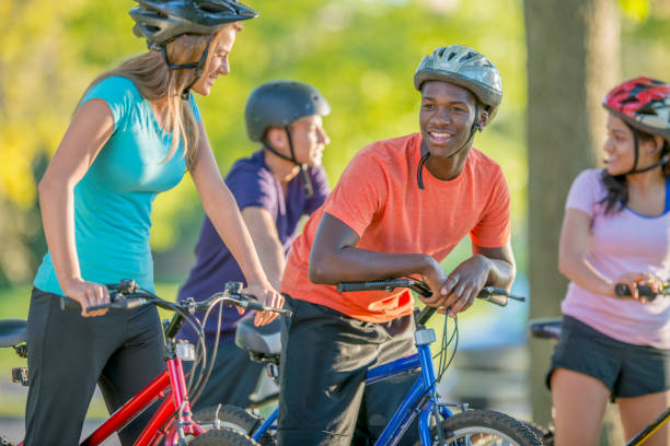 istock Friends cycling in the park 1072525784