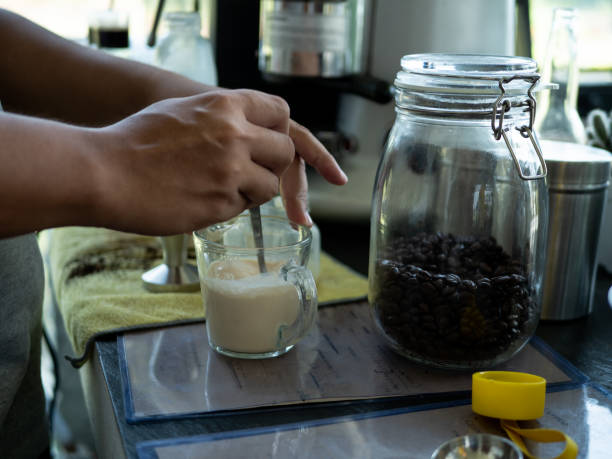istock Hand of Barista preparing cappuccino with coffee. 1072531114