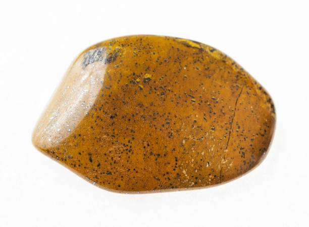 istock polished tiger's eye (tiger-eye) stone on white 1072531500