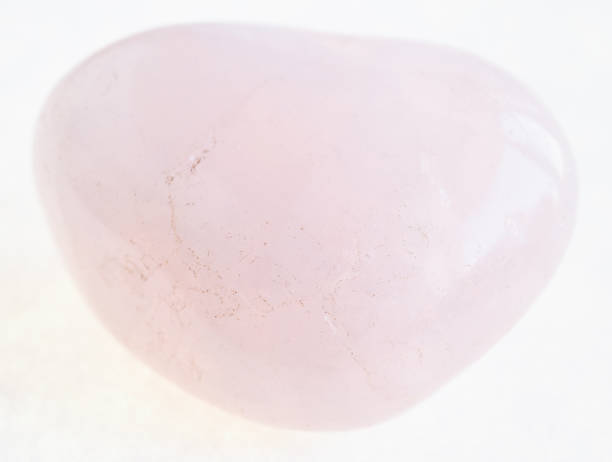 istock tumbled pink (rose) quartz stone on white 1072531578