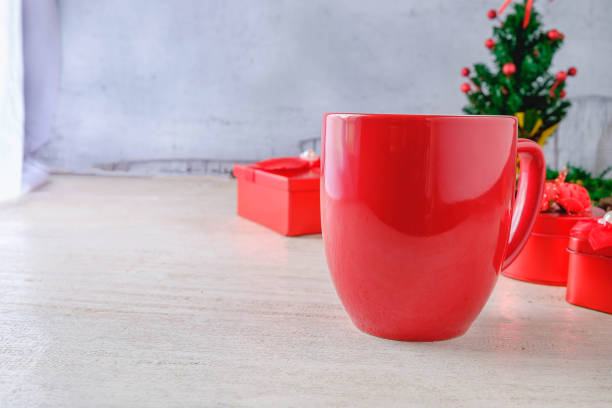 istock Red Coffee Cup and Red Gift Box with Christmas Tree on White Background Christmas day 1072532022