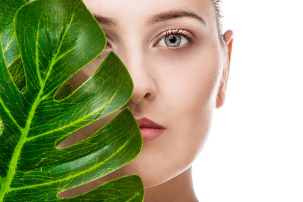 istock Woman portrait with tropical leaf 1072533118